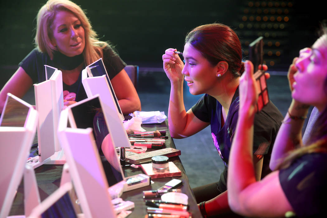 Coache Gabriella Versace, left, works on makeup with Marianne Tanada of Henderson during a prev ...
