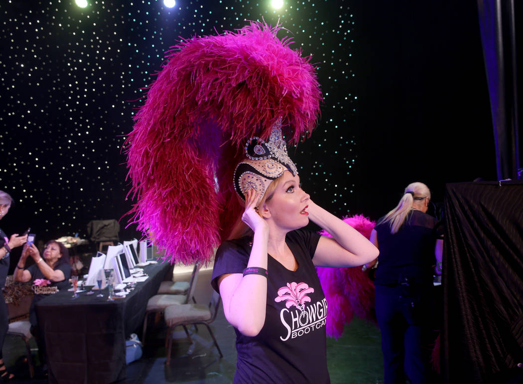 Jacqueline Hill of Henderson dons a dons a showgirl headdress during a preview of Showgirl Boot ...