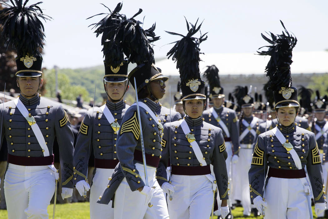 In this May 22, 2019 photo, cadet Isabella Minter, center, marches with senior class members du ...