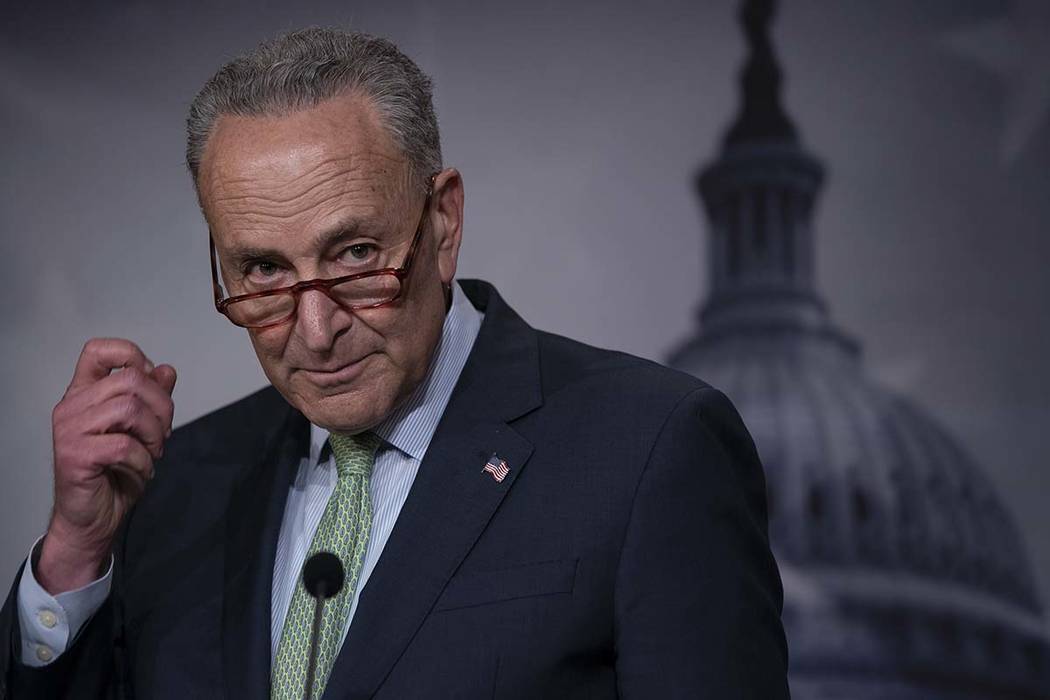 Senate Minority Leader Chuck Schumer, D-N.Y., talks to reporters just after the Senate passed a ...