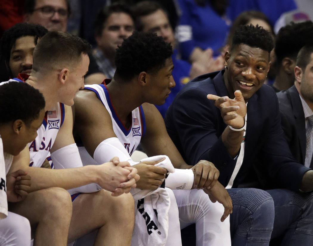 Kansas forward Silvio De Sousa, right, points to teammates during the second half of an NCAA co ...