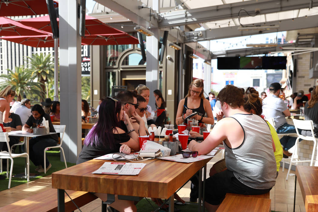 Patrons enjoy drinks at Beer Park at Paris Casino in Las Vegas on Sunday, April 1, 2018. (Andre ...