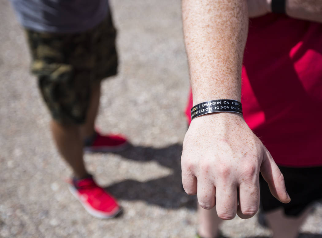 Sean Brown, president of UNLV Rebel Vets, shows a wristband memorializing a fallen friend while ...