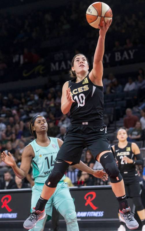 Aces guard Kelsey Plum (10) drives past New York Liberty guard Sugar Rodgers (14) in the first ...
