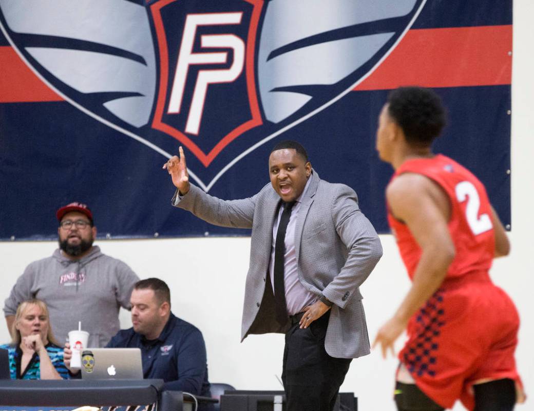 Findlay Prep head coach Rodney Haddix, middle, makes a call during the Pilot's home matchup wit ...