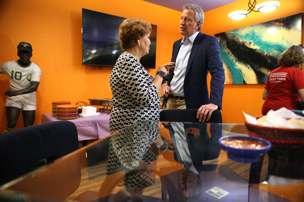 Donna West, left, the chair for the Clark Country Democratic party, speaks to New York Mayor Bi ...