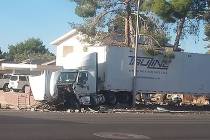 A semi-truck crashed into a residential brick wall on Windmill Lane at Wishing Well Road in Las ...
