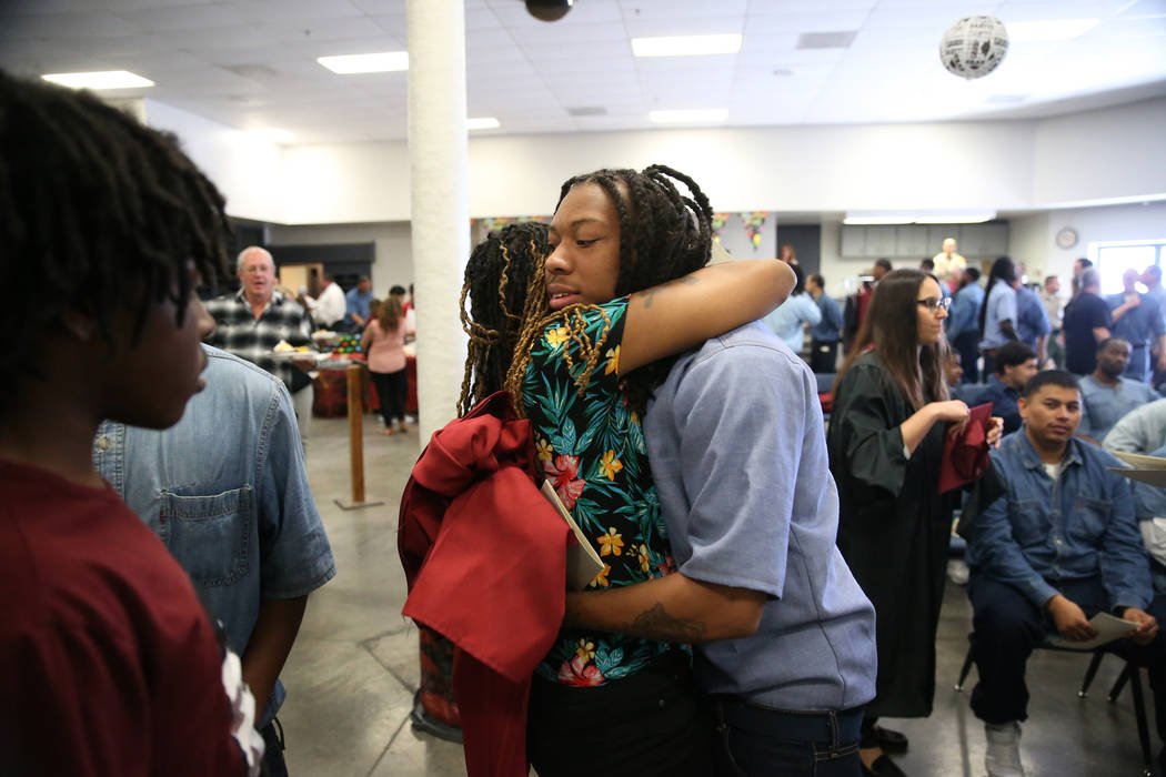 Inmate Trayvon Ward, right, 19, a former high school football standout from Las Vegas, embraces ...