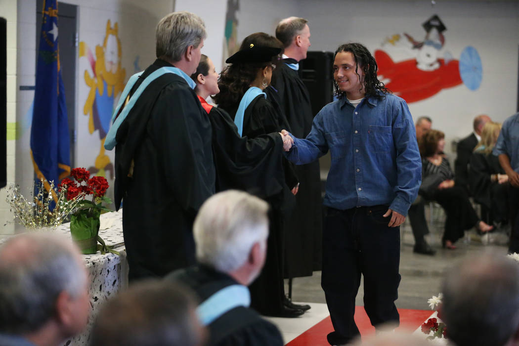Inmate Perfecto Gomez is recognized during his graduation from the Adult High School at the Hig ...