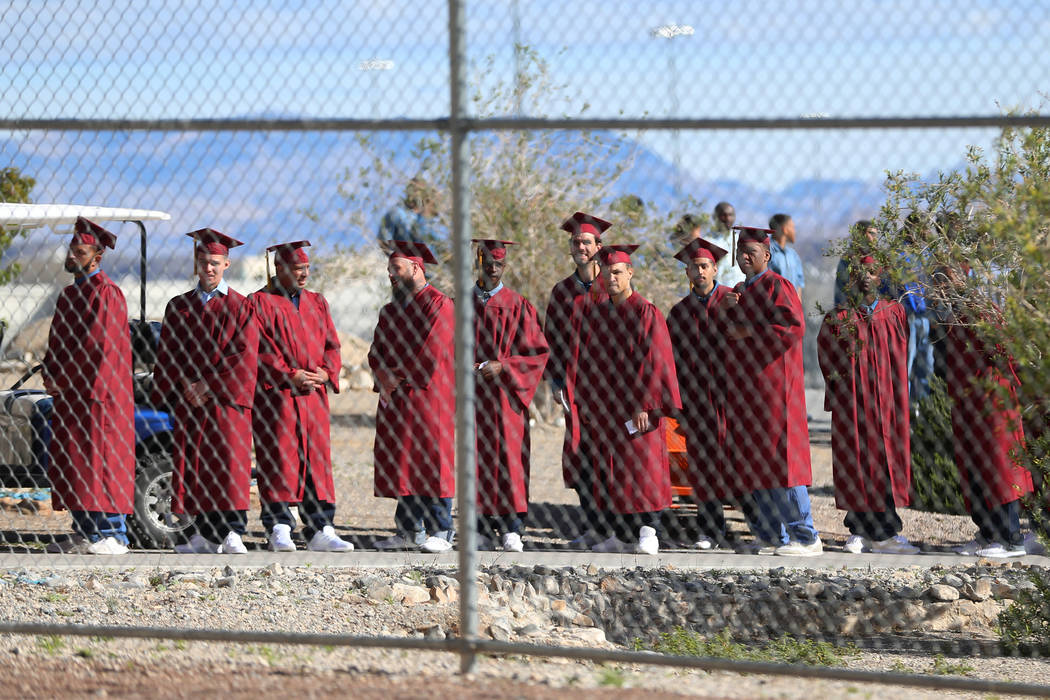 Inmates line up before making their way to their graduation at the High Desert State Prison in ...