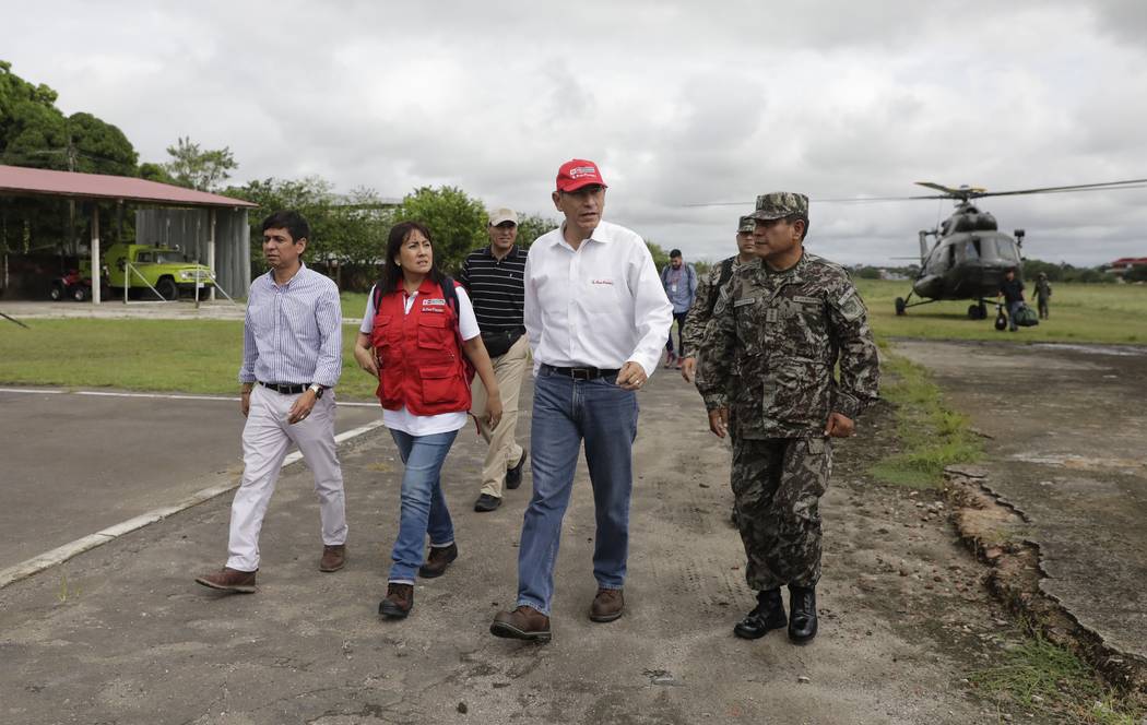 Peru's President Martin Vizcarra, second from right, arrives to the airport after checking eart ...