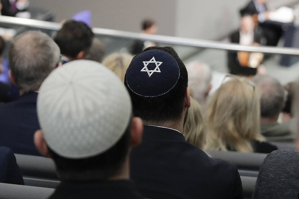 In this Thursday, Jan. 31, 2019, file photo, two men wearing skullcaps as they listen to the sp ...