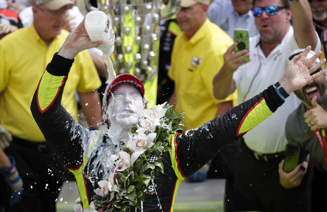 Simon Pagenaud, of France, celebrates after winning the Indianapolis 500 IndyCar auto race at I ...