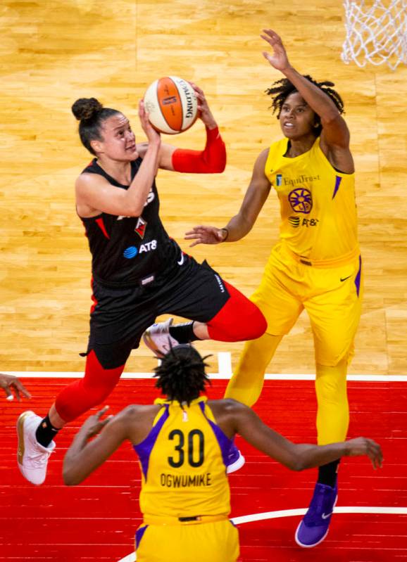 Las Vegas Aces guard Kayla McBride (21) elevates to the basket between Los Angeles Sparks forwa ...