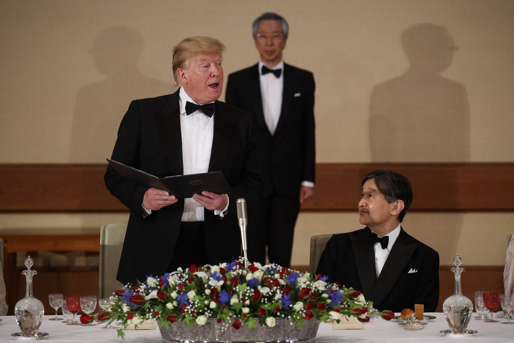 Japan's Emperor Naruhito, right, looks on as President Donald Trump speaks during a State Banqu ...