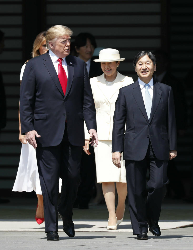 U.S. President Donald Trump, left, and first lady Melania Trump, rear left, are escorted by Jap ...