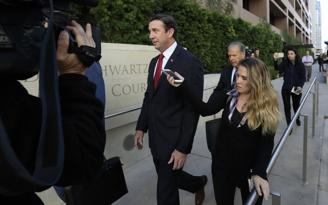 FILE - In this Dec. 3, 2018 file photo Republican Rep. Duncan Hunter, center, leaves court in S ...