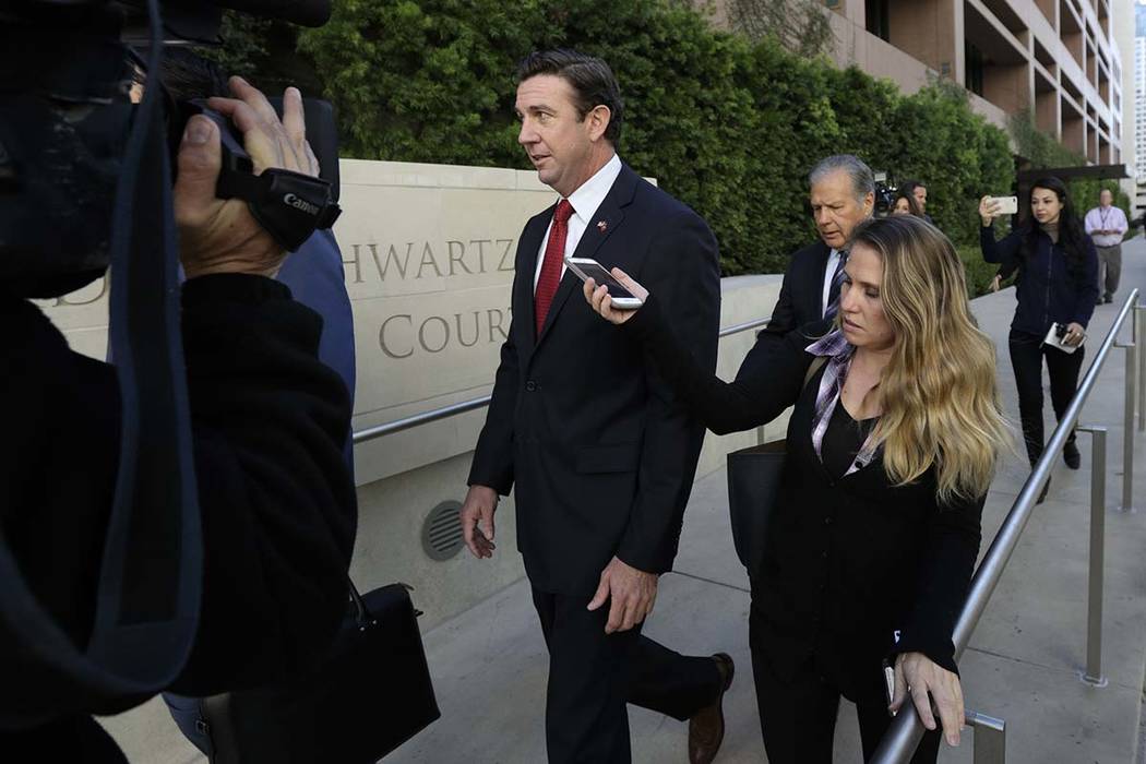 Republican Rep. Duncan Hunter, center, leaves court in San Diego, Dec. 3, 2018. Hunter has ackn ...