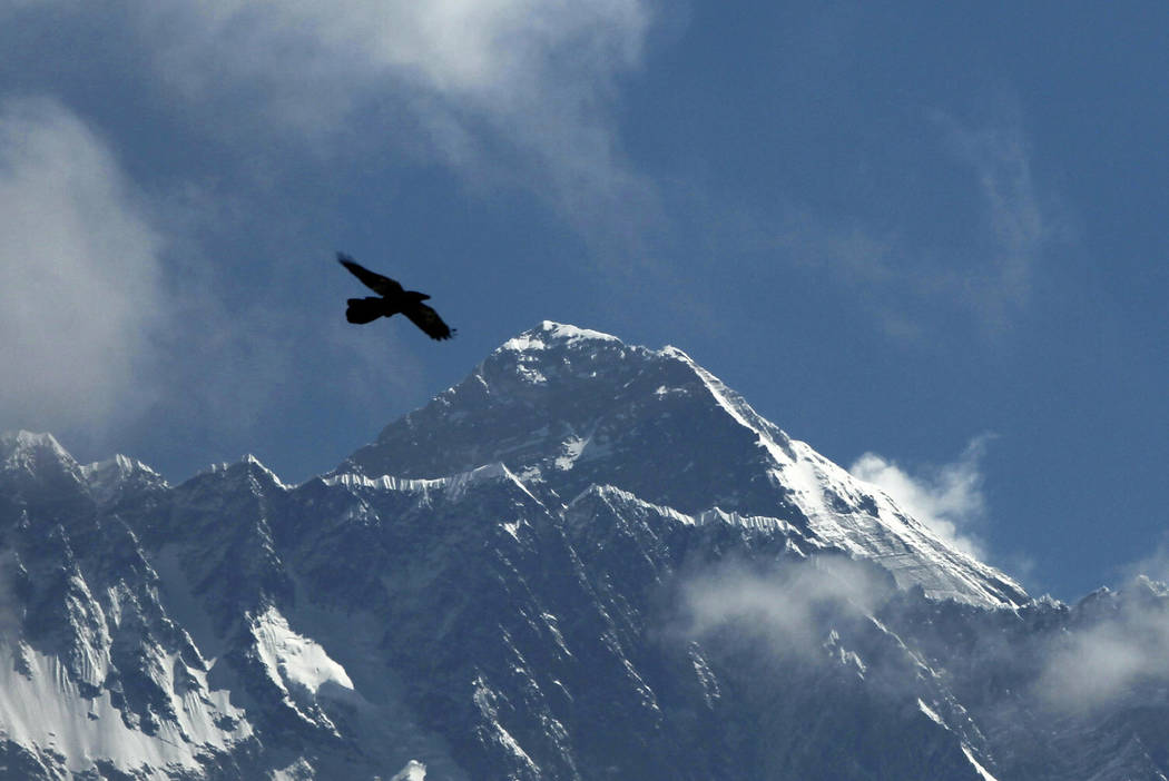 A bBird flies as Mount Everest is seen from Namche Bajar, Solukhumbu district, Nepal, Monday, M ...