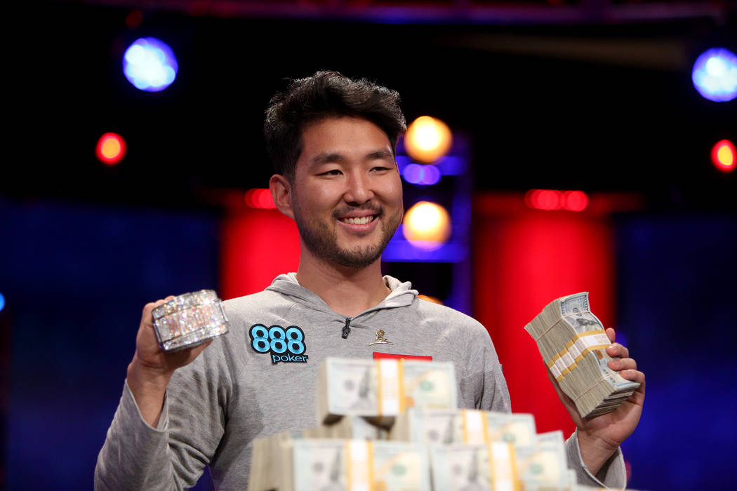 John Cynn holds his gold championship bracelet and cash after winning the World Series of Poker ...