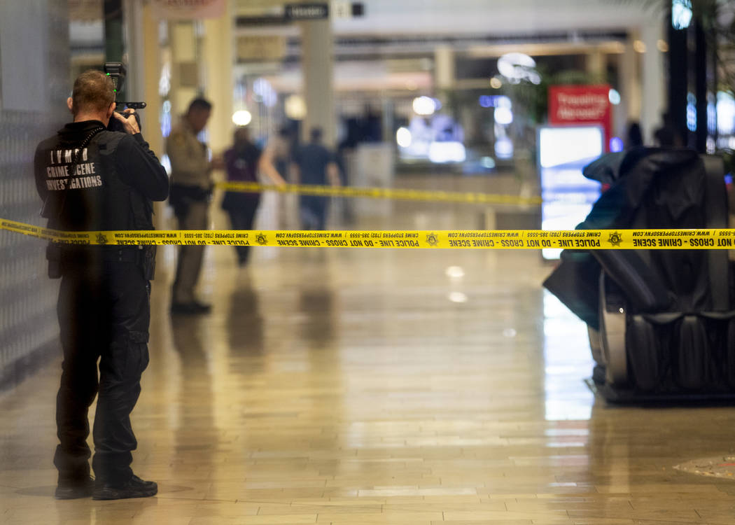 An LVMPD crime scene investigator shoots photographs inside the Fashion Show mall on the Strip ...