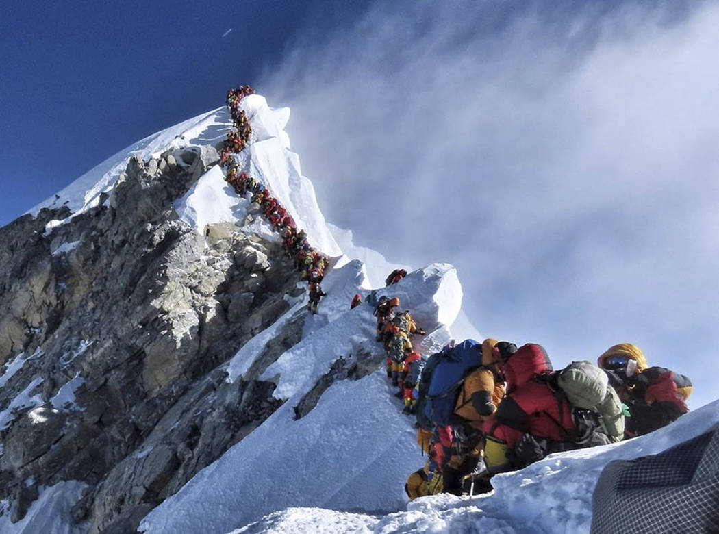 In this photo made on May 22, 2019, a long queue of mountain climbers line a path on Mount Ever ...