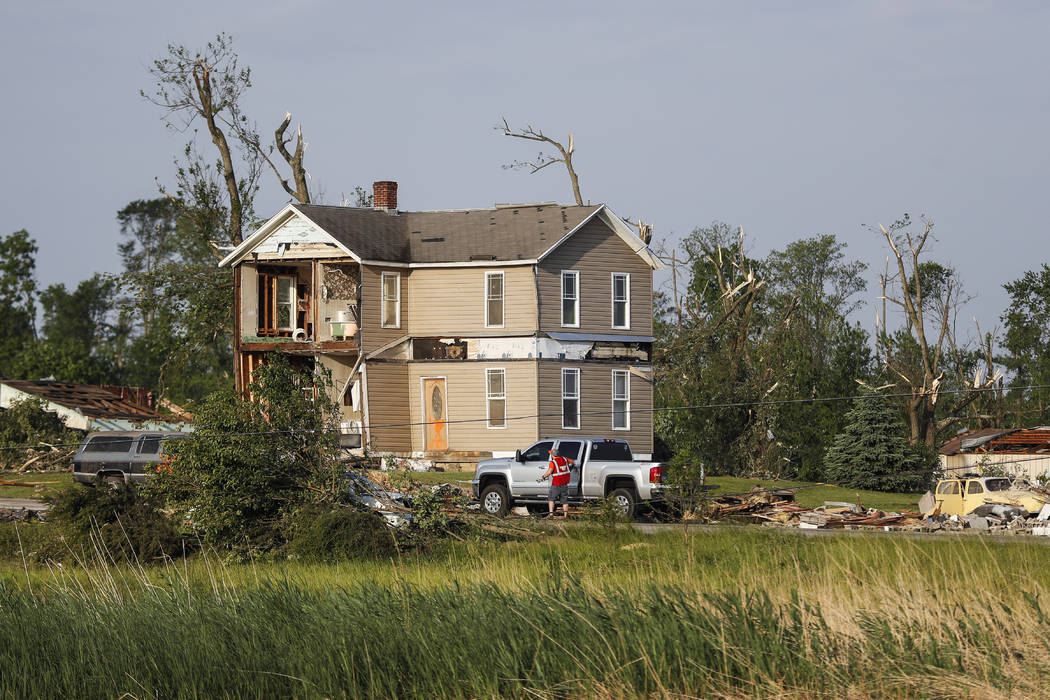 Homes stand damaged after a tornado passed through the area the previous evening, Tuesday, May ...