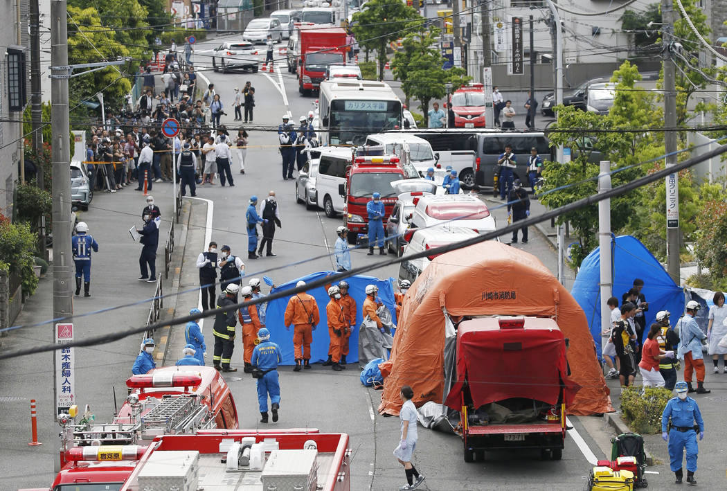 Rescuers work at the scene of an attack in Kawasaki, near Tokyo Tuesday, May 28, 2019. A man wi ...