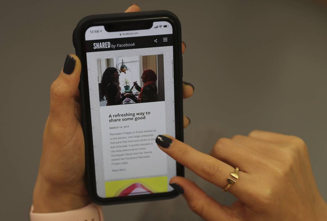 In this Monday, May 20, 2019 photo, a woman looks at a Ramadan-related page on her mobile phone ...