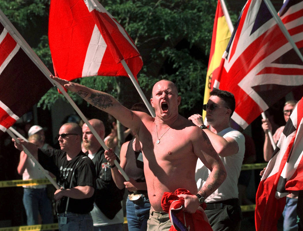 FILE - In this July 18, 1998, file photo, Karl Wolf raises his arm in a Nazi salute as he march ...