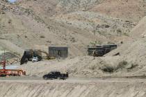 In a May 25, 2019 photo, construction workers install sections of fencing for a privately-funde ...