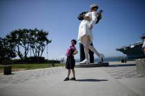 In a Sept. 18, 2015, file photo a tourist from China stands in front of the sculpture "Uncondit ...