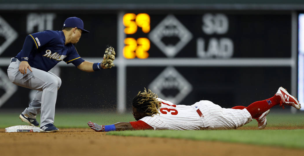 Philadelphia Phillies' Odubel Herrera, right, steals second base past Milwaukee Brewers second ...