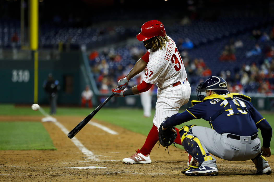 Philadelphia Phillies' Odubel Herrera, left, hits a two-run double off Milwaukee Brewers relief ...