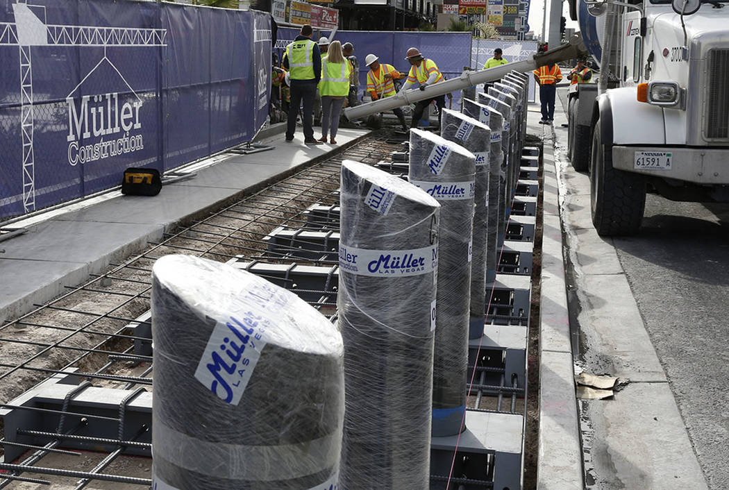 Construction crews pour cement where they began installing steel posts on the Las Vegas Strip n ...