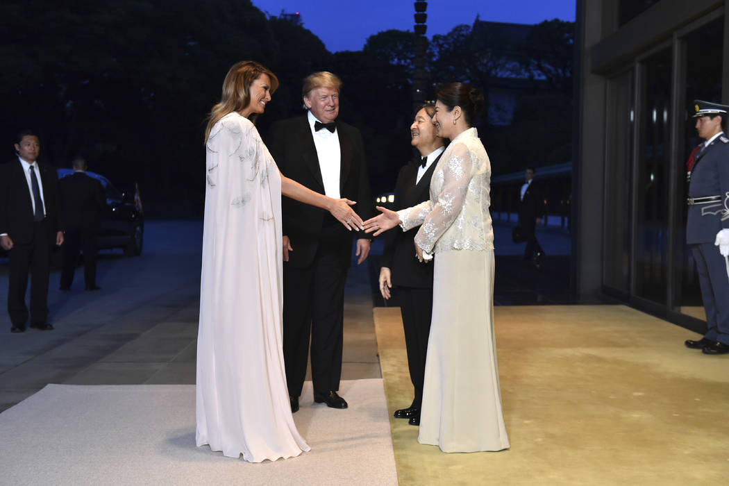 U.S. President Donald Trump, center left, and First lady Melania Trump, front left, are greeted ...