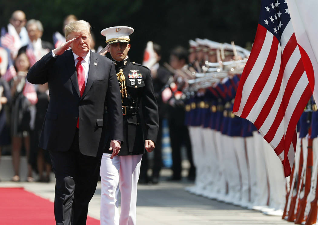 U.S. President Donald Trump, left, reviews an honor guard during a welcome ceremony at the Impe ...