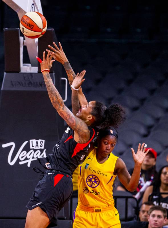 Las Vegas Aces forward Tamera Young (1) gets off a second shot over Los Angeles Sparks guard Al ...