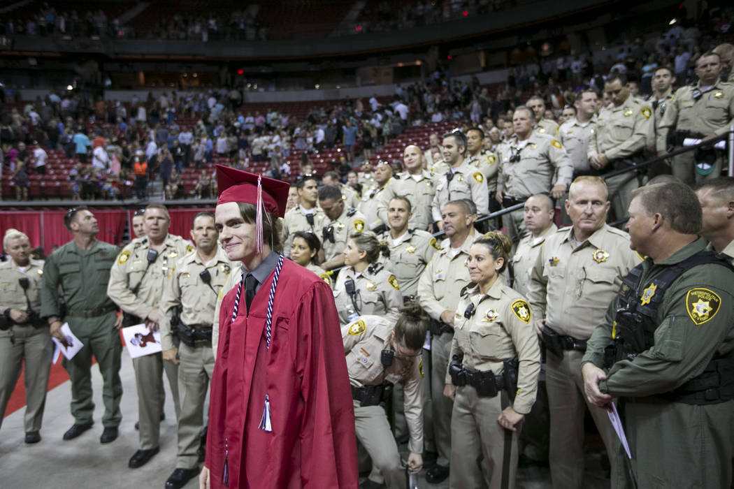 Daxton Beck, the son of slain Las Vegas police officer Alyn Beck, poses for photos with officer ...