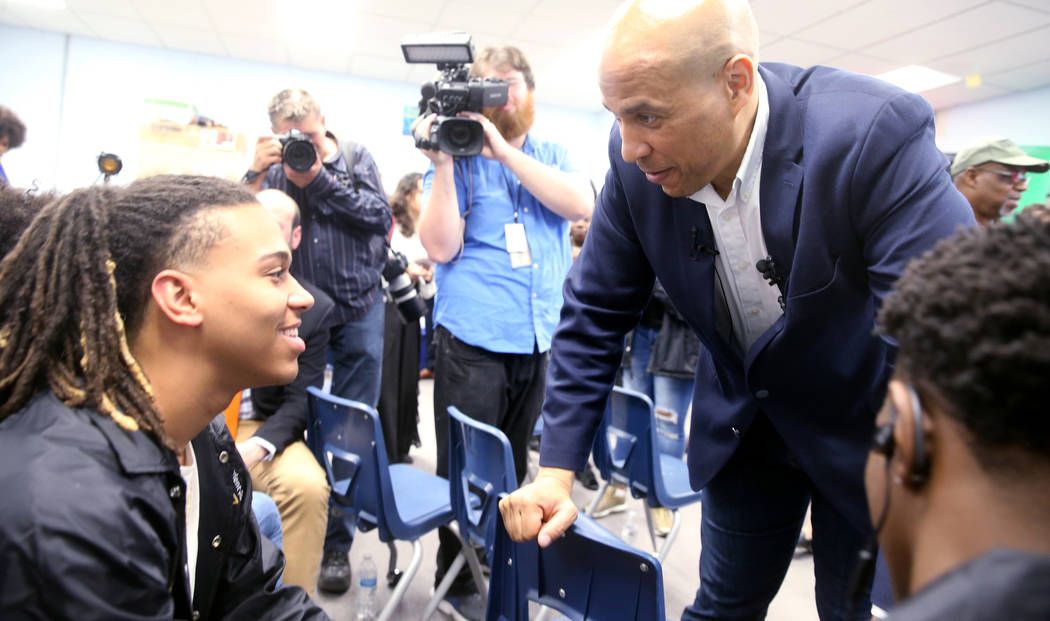 Presidential hopeful Sen. Cory Booker, D-N.J., visits with Cheyenne High School seniors Jeremia ...