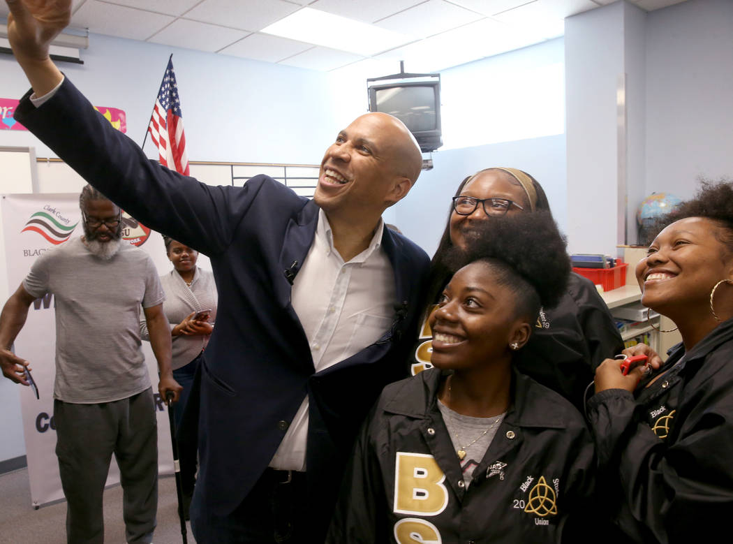 Presidential hopeful Sen. Cory Booker, D-N.J., takes a selfie with Cheyenne High School seniors ...