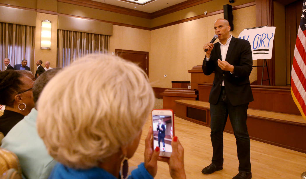 China Frazier of Henderson takes a photo of presidential hopeful Sen. Cory Booker, D-N.J., spea ...