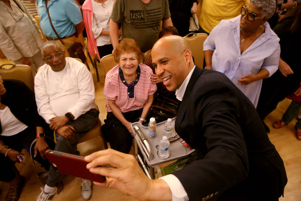 Presidential hopeful Sen. Cory Booker, D-N.J., takes a selfie with Lucille Lucas of Henderson d ...