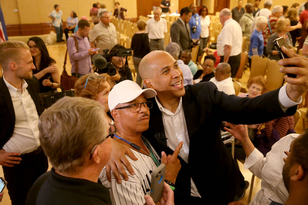 Presidential hopeful Sen. Cory Booker, D-N.J., takes a selfie with Jonathan Collins of Henderso ...