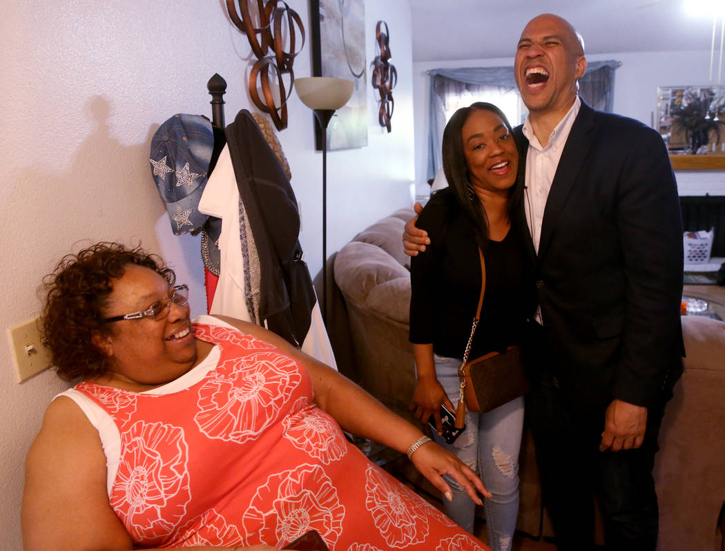 Presidential hopeful Sen. Cory Booker, D-N.J., visits with Linda Green, left, and Nedra Shields ...