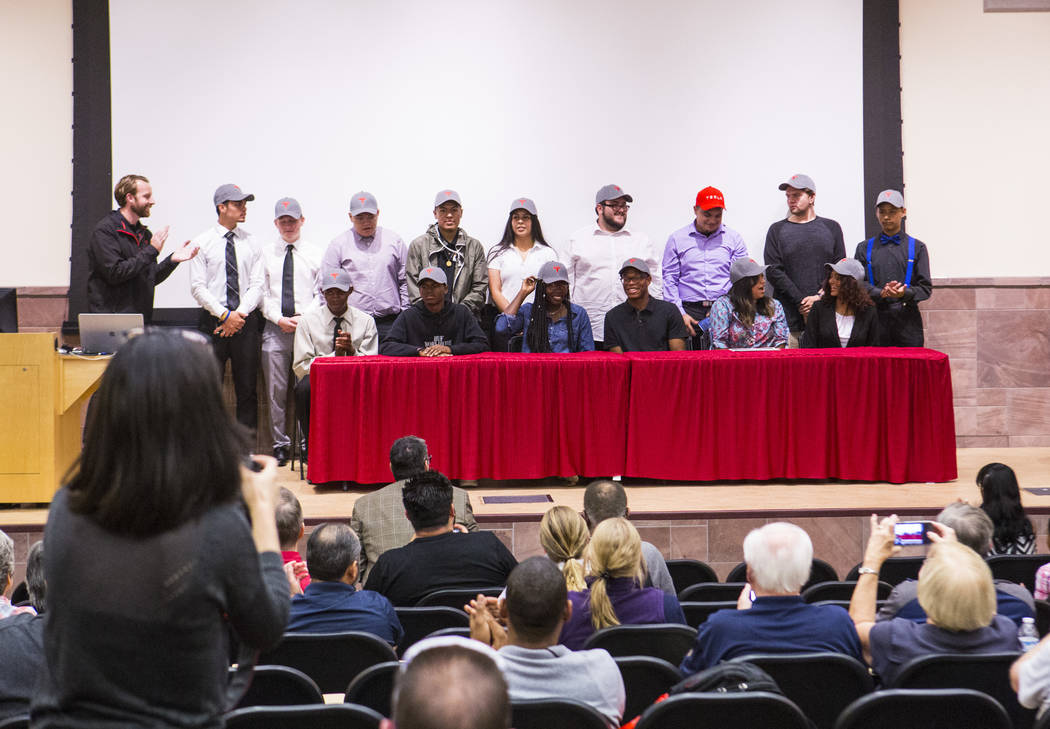 New Tesla hires, who recently graduated high school, pose for a photo after a signing ceremony ...