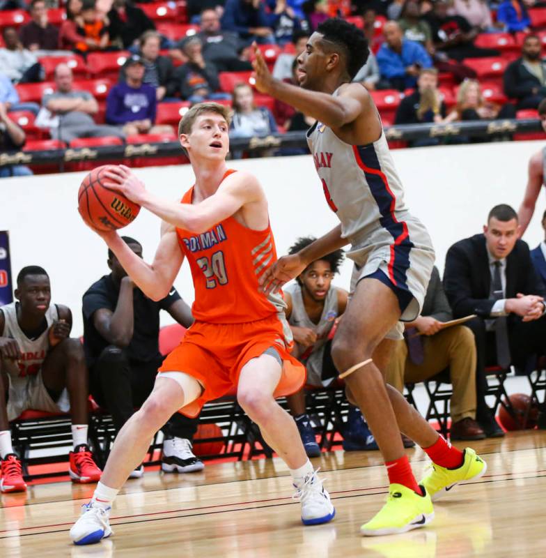 Bishop Gorman's Noah Taitz (20) tries to get the ball around Findlay Prep's Aston Smith during ...