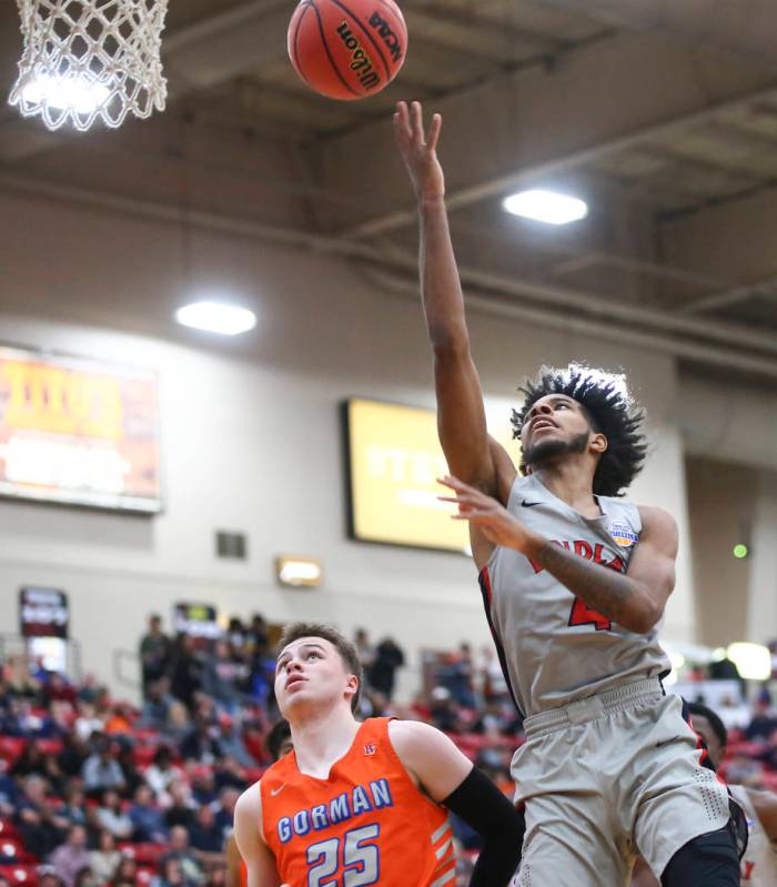 Findlay Prep's P.J. Fuller goes to the basket against Bishop Gorman's Chance Michels (25) durin ...