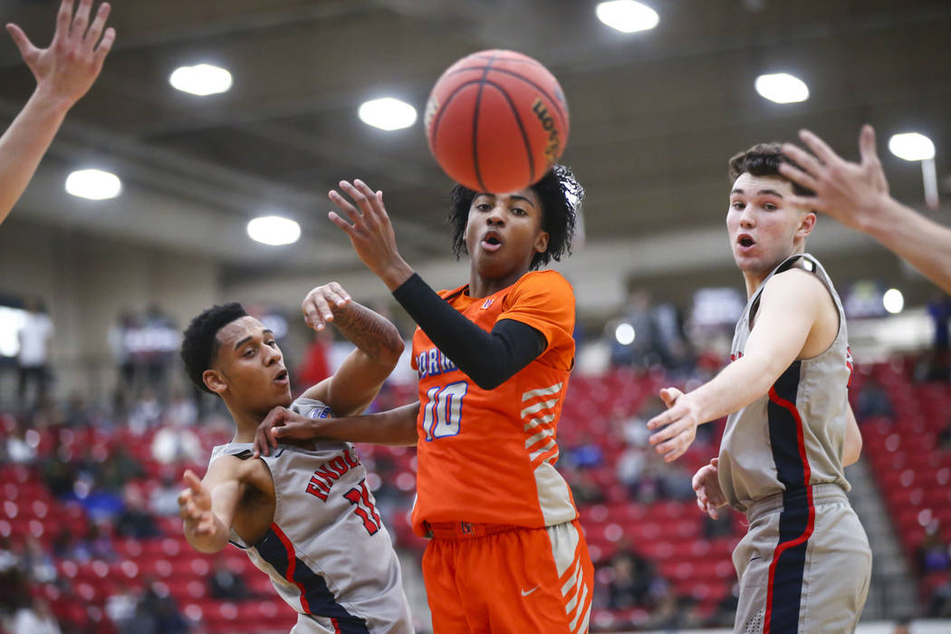 Bishop Gorman's Zaon Collins (10) watches a loose ball between Findlay Prep's Taryn Todd (11) a ...