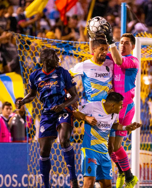 (From right) Las Vegas Lights FC goalkeeper Thomas Olsen (1) grabs a kicked ball above the head ...
